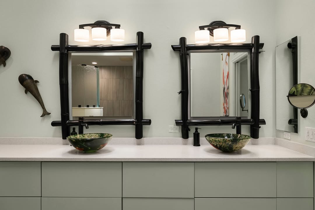 Double vanity with sculptural mirrors and vessel sinks